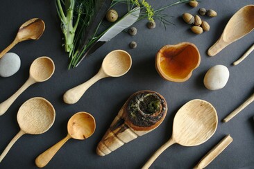 A collection of handmade wooden utensils from above.