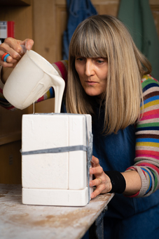 Hanne Rysgaard filling up the slip casting mould