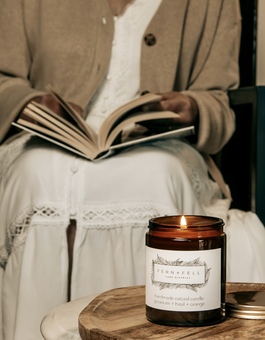 Women reading a book with a candle lit